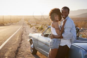 Portrait Of Romantic Couple Enjoying Road Trip In Classic Car