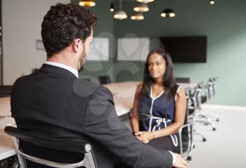 Businessman Interviewing Female Candidate At Graduate Recruitment Assessment Day In Office