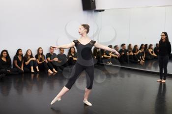 Female Ballet Student At Performing Arts School Performs For Class And Teacher In Dance Studio