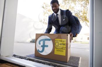 Businessman Coming Home To Fresh Food Home Delivery In Cardboard Box Outside Front Door