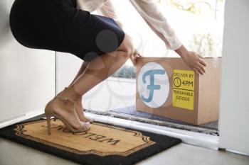 Close Up Of Woman Opening Front Door To Fresh Food Home Delivery In Cardboard Box Outside Front Door
