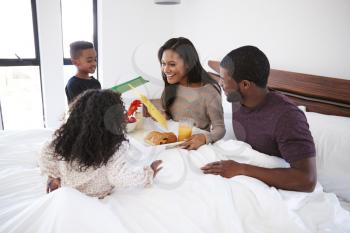 Children Bringing Mother Breakfast In Bed To Celebrate Mothers Day Or Birthday