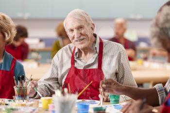 Portrait Of Retired Senior Man Attending Art Class In Community Centre