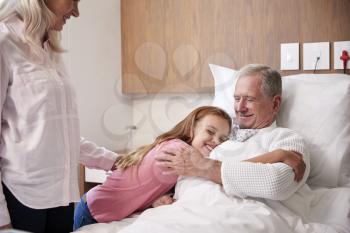 Granddaughter Hugging Grandfather On Family Hospital Visit