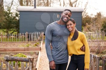 Outdoor Portrait Of Couple Spending Vacation In Eco Lodge