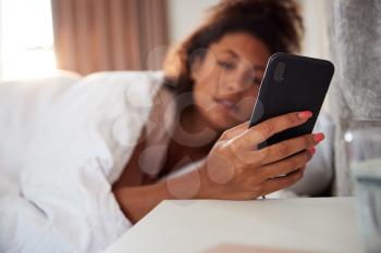 Woman Waking Up In Bed Immediately Reaches Out To Look At Mobile Phone