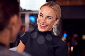 Two Women Meeting For Drinks And Socializing In Bar After Work
