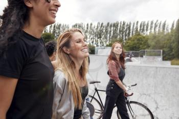 Group Of Female Friends Walking Through Urban Skate Park