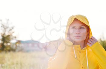 Unhappy Woman Wearing Waterproof Coat At Outdoor Music Festival