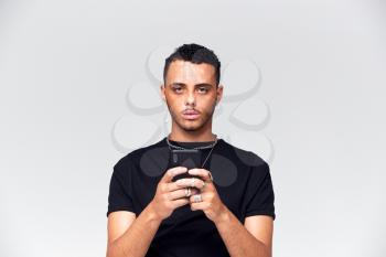 Portrait Shot Of Causally Dressed Young Man Using Mobile Phone