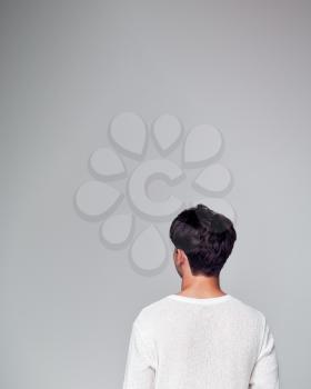 Rear View Of Young Man Looking Away From Camera In Studio
