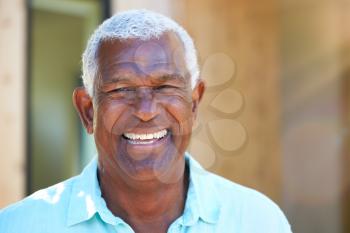 Portrait Of Smiling Senior African American Man Outdoors In Garden At Home