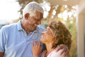 Portrait Of Smiling Senior African American Couple In Garden At Home