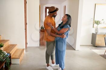Loving African American Couple Hugging And Dancing In Hall At Home