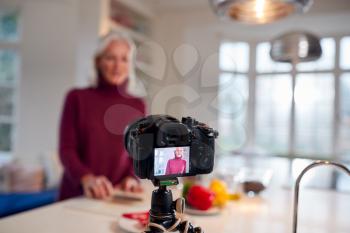 Senior Female Vlogger Making Social Media Video About Cooking For The Internet At Home