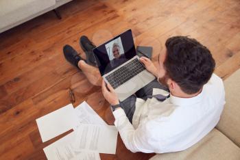Businessman Wearing Loungewear And Shirt And Tie For Video Call On Laptop Working From Home