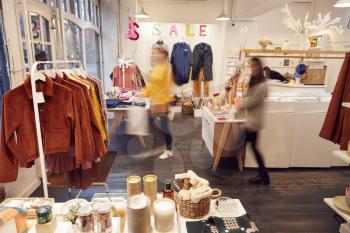 Interior View Of Clothing And Gift Shop With Motion Blurred Customers