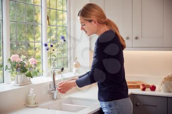 Woman Washing Hands With Soap At Home To Stop Spread Of Infection In Health Pandemic