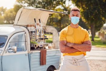 Portrait Of Man Wearing Face Mask Running Independent Mobile Coffee Shop Standing Next To Van