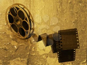 Royalty Free Clipart Image of a Film Reel on a Grunge Background