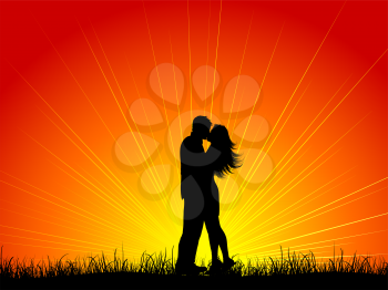 Silhouette of a couple kissing against a sunset sky