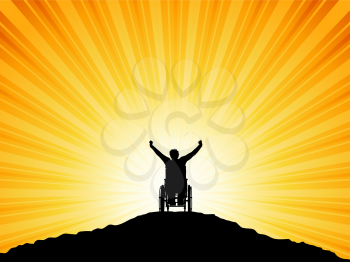 Silhouette of a man in a wheelchair with his arms raised in success