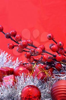 Christmas background of berries, gifts, baubles and tinsel