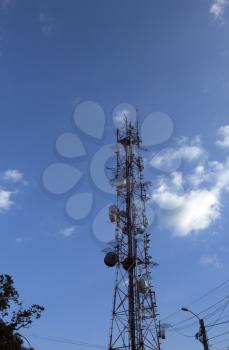 Telecommunication tower, cell antenna, transmitter, cell phone tower, telecom radio tower over a blue