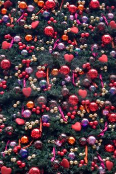 The golden balls and heart hang on ribbons. A perfect christmas background!