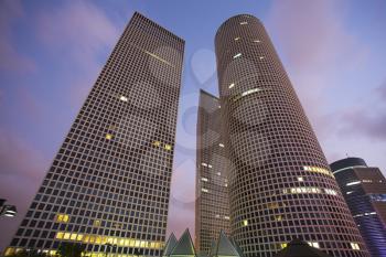 Round, square and triangular skyscrapers in business part Tel-Aviv on a sunset