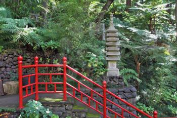Lovely park on the island of Madeira. Monte Palace Tropical Garden. The red Chinese-style railing along the steps