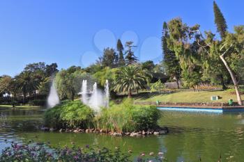 Picturesque lake with islands and fountains. The magnificent city park in Funchal. 