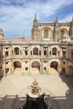 The imposing medieval castle of the Knights Templar in Portugal. The fountain in the center of the patio