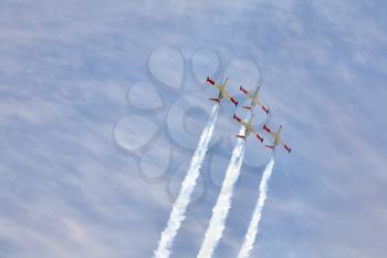 Synchronous delightful flight of four sparkling planes on air parade