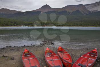  Red boats on a sandy shallow of mountain lake
