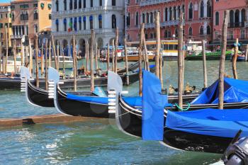 Wonderful holiday in Venice. Graceful gondola approached by a magnificent old palaces.