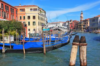 The famous Grand Canal in Venice. Graceful black gondolas wait for passengers on the mooring at the palace. Photo taken by lens Fisheye