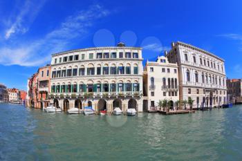 Great Venetian palazzo, surrounded by mirrored waters of the channel. Photo making the lens Fisheye