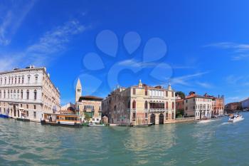 Magnificent Venetian palace on a sunny day, surrounded by the waters of the channel. Photo taken by lens Fisheye