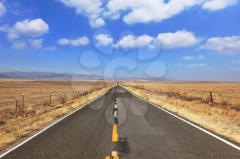 Ideal road. The magnificent equal highway through boundless to the desert