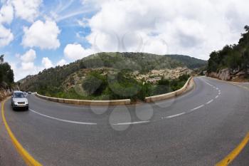 The car on abrupt turn of the mountain road, photographed by an objective  Fish eye 