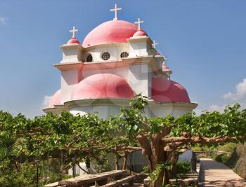   Orthodox church on coast of the lake of Tiberias, shined by the sun, a church garden and a vineyard