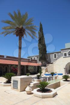 A cozy patio, covered galleries, palm and cypress trees in the tourist center near Beit She'an. Israel
