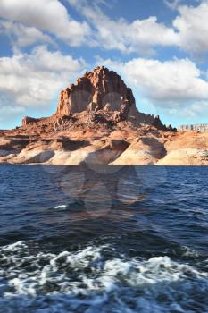  Lakeside in red sandstone covered sunset. Boat trip on the picturesque Lake Powell.
