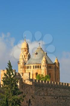  The morning sun illuminates the dome and the tower of the abbey.  The Catholic Church of Dormition in Jerusalem.