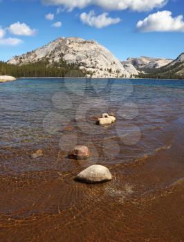 Picturesque beach at the shallow lake in the mountains of Tioga Pass, Yosemite Park
