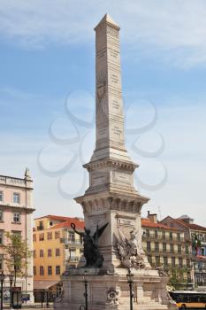 The giant obelisk in the center of Lisbon. The obelisk is decorated with allegorical winged figures