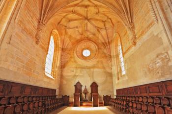 The imposing medieval castle of the Knights Templar in Portugal. The magnificent chapel with a vaulted ceiling and rows of oak chairs