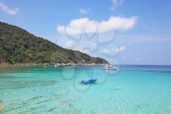 The picturesque shores of magical Similan Islands. Shallow beach with warm turquoise waters fenced enclosure rope with floats