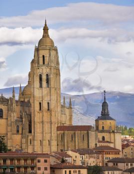 Cathedral in Segovia on a background of the cloudy sky and mountains